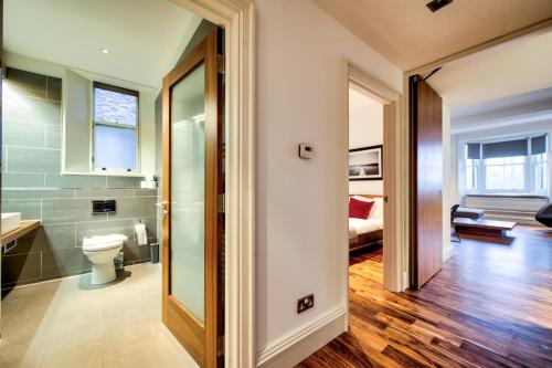 a bathroom with a toilet and a sink at Sumptuous 2BR Apt Next To Edinburgh Castle! in Edinburgh