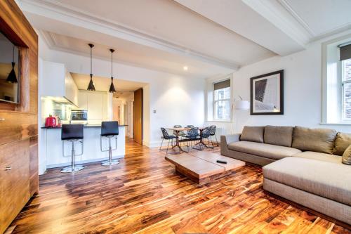 a living room with a couch and a table at Sumptuous 2BR Apt Next To Edinburgh Castle! in Edinburgh