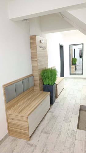 a room with a bench and a potted plant at Penzion HARMONIE in Trhové Sviny