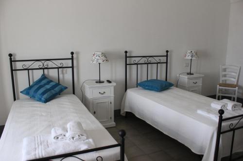 two beds sitting next to each other in a bedroom at Tenuta Orsanese in Ginosa Marina