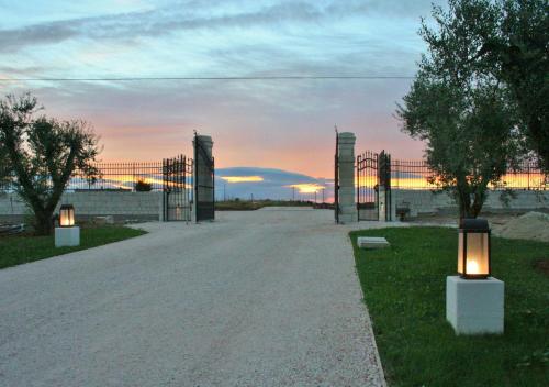 an empty road with two lights in the grass at Tenuta Orsanese in Ginosa Marina