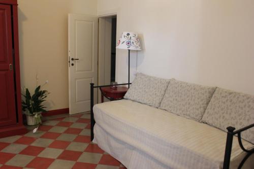 a bedroom with a bed and a checkered floor at Tenuta Orsanese in Ginosa Marina