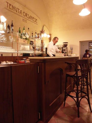 a man standing at a bar in a restaurant at Tenuta Orsanese in Ginosa Marina