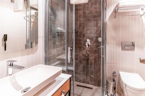 a bathroom with a shower and a sink and a toilet at PEARLY HOTEL in Antalya