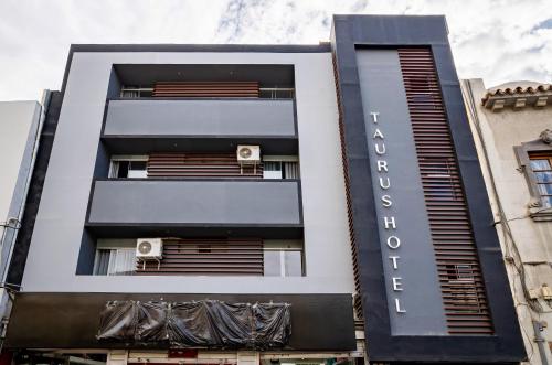 a building with a black and white facade at Hotel Taurus in Piura