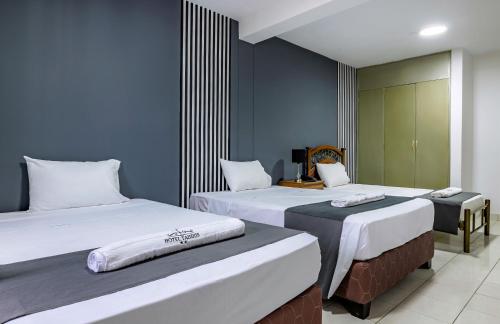 Hotel Taurus tesisinde bir odada yatak veya yataklar