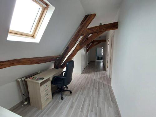 an attic office with a desk and a window at La Ribote in Sancerre
