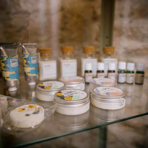 a glass shelf with jars of candles on it at Apartmány Dačický 2 in Kutná Hora