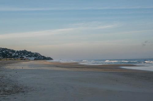 an empty beach with the ocean in the background at El Cortijo de Zahara by QHotels in Zahara de los Atunes