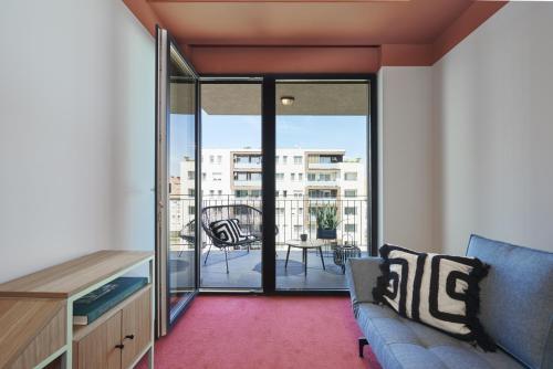 a living room with a couch and a balcony at SmartApart in Budapest
