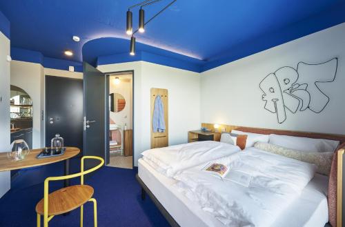 a bedroom with a large bed with a blue ceiling at SmartApart in Budapest
