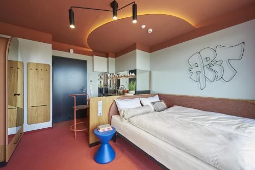 a bedroom with a large bed and a kitchen at SmartApart in Budapest
