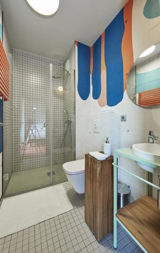 a bathroom with a shower and a toilet and a sink at SmartApart in Budapest