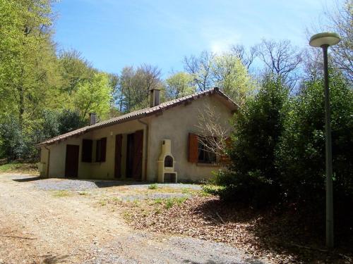 a small house sitting on top of a dirt road at Les gîtes de la Planette - gîte 3 in Saint-Amans-Valtoret