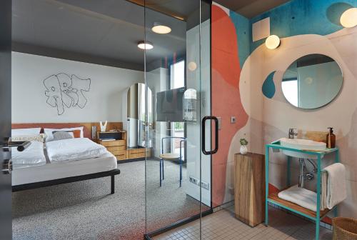 a bedroom with a bed and a sink and a mirror at SmartApart in Budapest