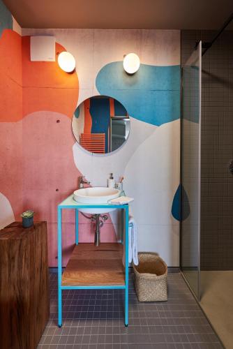 a bathroom with a sink and a mirror at SmartApart in Budapest