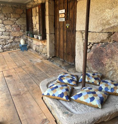 a group of pillows sitting on a porch at Casa Las Piedras in Padrenda