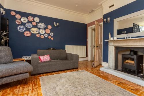 a living room with a couch and a fireplace at St Marks Stays in Sedbergh