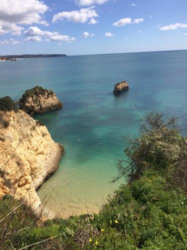 a view of the ocean with rocks in the water at Apartamento Praia do Vau in Alvor
