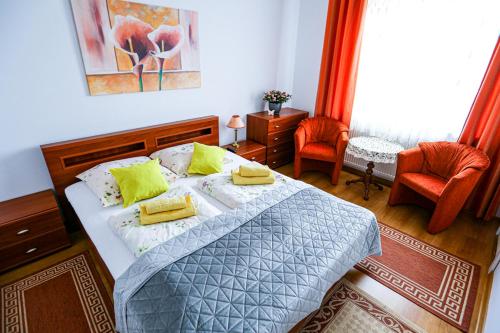 a bedroom with a bed with two towels on it at Villa Nadmorska Łeba Centrum in Łeba