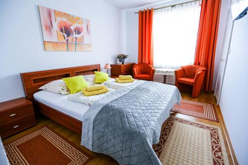 a bedroom with a bed with two yellow pillows on it at Villa Nadmorska Łeba Centrum in Łeba