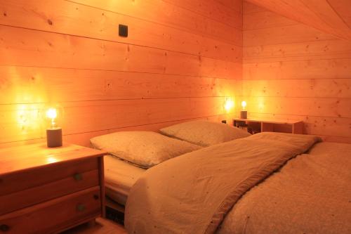 a bedroom with two beds and two candles in it at Belladone Guest House theys Les 7 Laux in Theys