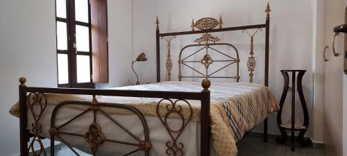 a bedroom with a bed with a metal frame at Vathia Tower 1894 in Váthia