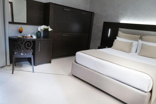 1 dormitorio con 1 cama grande y 1 mesa en Villa Caribe, en Spigno Saturnia
