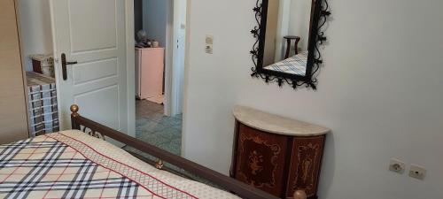 a bedroom with a bed and a mirror on the wall at Vathia Tower 1894 in Váthia