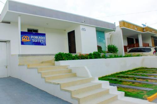 a building with a staircase in front of it at Hotel Poblado Suite in Barranquilla