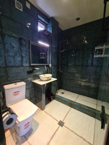 a bathroom with a shower and a toilet and a sink at Batumi Wonderland in Batumi