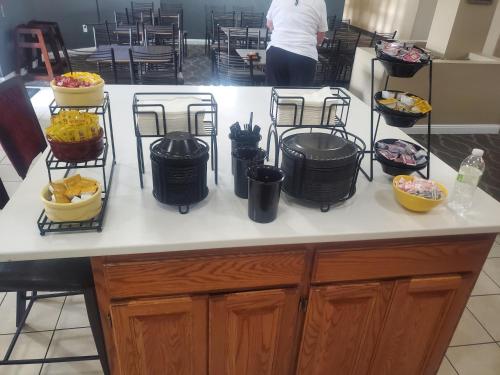 a counter with several baskets of food on it at GrandStay Hotel & Suites Ames in Ames