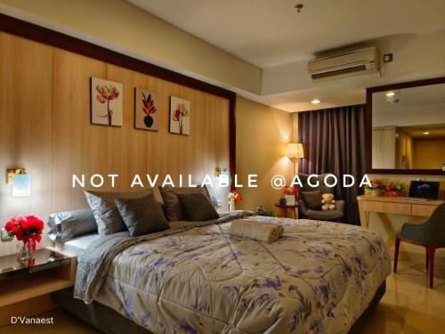 a bedroom with a bed with a not available oacoco sign on it at D'Vanaest in Semarang
