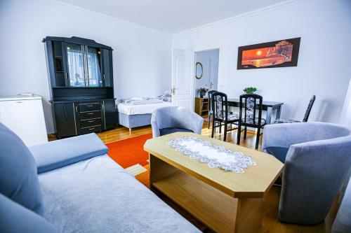 a living room with a couch and a table at Villa Nadmorska Łeba Centrum in Łeba