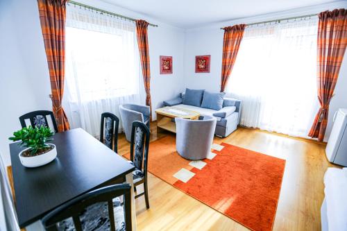 a living room with a table and a couch at Villa Nadmorska Łeba Centrum in Łeba