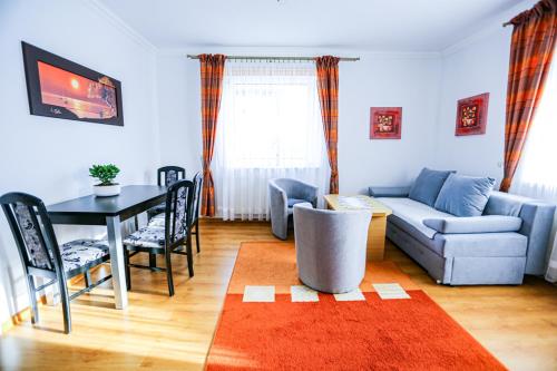 a living room with a couch and a table at Villa Nadmorska Łeba Centrum in Łeba