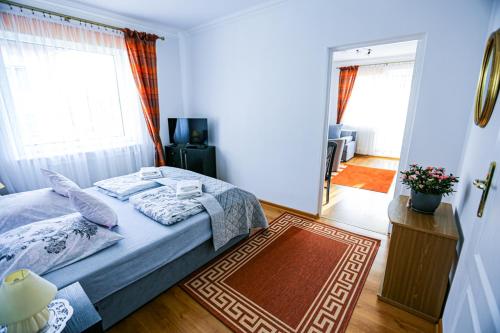 a bedroom with a bed and a mirror at Villa Nadmorska Łeba Centrum in Łeba
