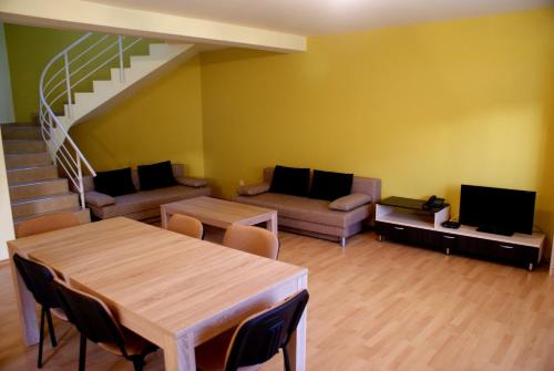 a living room with a table and a couch at Casa Ardeleneasca in Timişoara