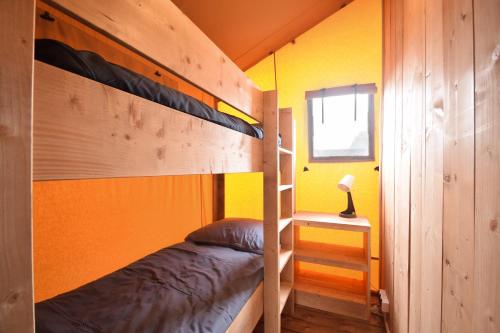 a small bedroom with a bunk bed and a window at Baza Maciejòwka in Międzywodzie