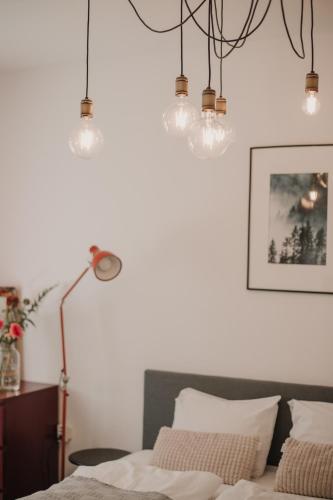 a bedroom with a bed with two pillows and lights at Gallery Apartment 2 in Martin