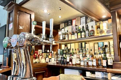 a bar filled with lots of bottles of alcohol at The Buckley Arms in Dinas Mawddwy