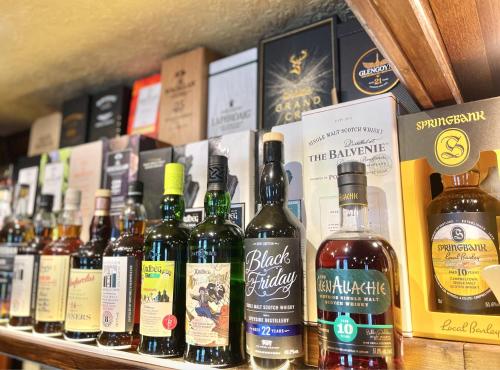 a bunch of bottles of wine on a shelf at The Buckley Arms in Dinas Mawddwy