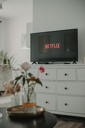 a tv sitting on top of a white dresser at Gallery Apartment 2 in Martin