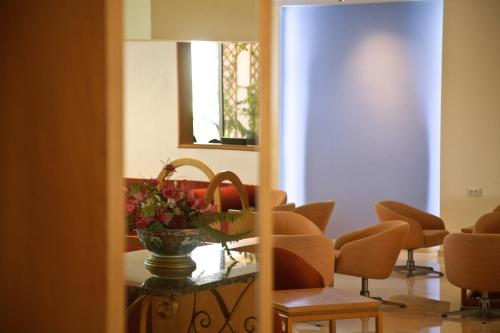 a room with chairs and a table and a mirror at Blue Horizon in Ialyssos