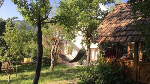 a hammock in a yard next to a house at Dil Hill by Sam in Dilijan
