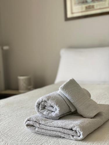 a pile of towels sitting on top of a bed at Sottovento B&B in Trani