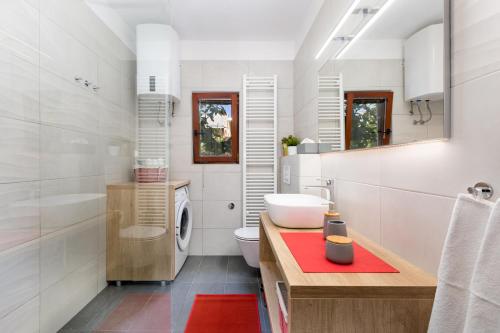 a bathroom with a sink and a washing machine at Home Away From Home with a heated pool in Punat