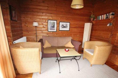 a living room with a couch and chairs and a table at Ferienpark Lauterdörfle 9 in Hayingen