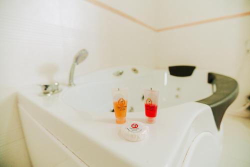 a bathroom sink with two drinks on it at Ras Amba Hotel in Addis Ababa