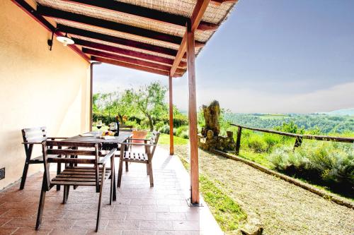 a table and chairs on a patio with a view at Agriturismo Poggio Pistolese in Montaione